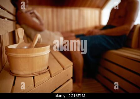 A young couple enjoying in a relaxed atmosphere at sauna. Relationship, leisure, relaxation Stock Photo