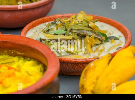 Kerala traditional feast side dishes arranged  in grey colour background,selective focus. Stock Photo