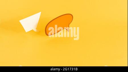 paper speech bubbles on yellow background Stock Photo - Alamy