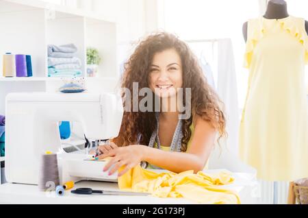 Seamstress working on sewing machine Stock Photo