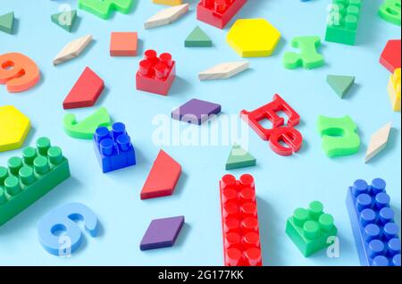 Background from letters of the English alphabet, numbers and a children's constructor. Child development and learning concept Stock Photo