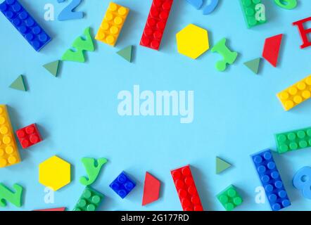 Background from letters of the English alphabet, numbers and a children's constructor with a place for the text. Child development and learning Stock Photo