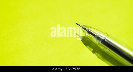 Ball pen on a bright green paper. Stock Photo