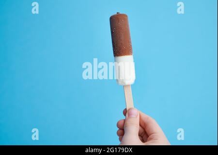vanilla ice cream stick on blue background with copy space Stock Photo