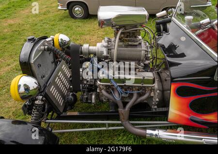 A Rover V8 engine with a supercharger in a custom model T at a classic car show Stock Photo