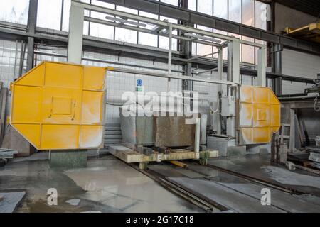 Stone wire saw. Machine for cutting granite stones. Cutting granite in a stonemason's workshop. Single Wiresaws Stock Photo