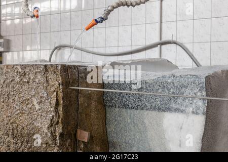 Stone wire saw. Machine for cutting granite stones. Cutting granite in a stonemason's workshop. Single Wiresaws Stock Photo