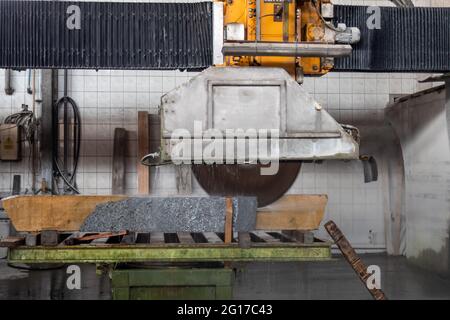 Machine for cutting granite stones. Cutting granite in a stonemason's workshop. Stock Photo