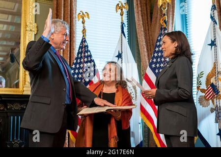 U.S Vice President Kamala Harris holds a ceremonial swearing in of Eric Lander as the Director of the Office of Science and Technology Policy, as his wife Lori Lander holds a 500-year-old Hebrew text, in the Eisenhower Executive Office Building of the White House June 2, 2021 in Washington, DC. Stock Photo