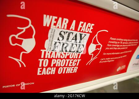 London, UK, 3 June 2021: While most people wear face masks on public transport, a few don't due to health issue or as a rebellion against government advice. A sticker from the Join The White Rose movement advises 'Stay Free', defacing a Transport for London and Mayor of London poster asking people to wear face masks to reduce the spread of covid. Anti-vaxxers and lockdown sceptics are campaigning in defiance of scientific advice and a possible third wave of covid infections in the UK. Anna Watson/Alamy Stock Photo