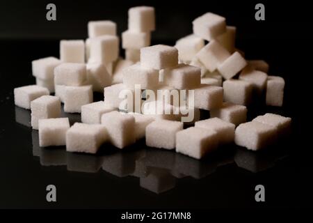 Sugar cubes in different arrangements and colored light. Arrows, Cubes, Pile, Square. Bavaria Germany Stock Photo