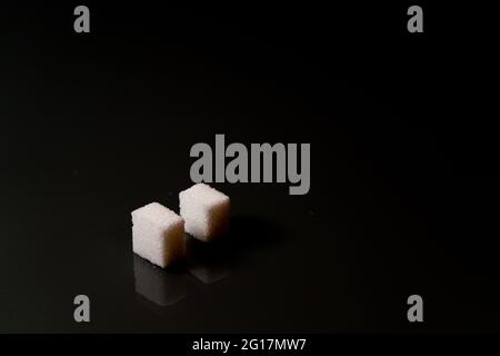 Sugar cubes in different arrangements and colored light. Arrows, Cubes, Pile, Square. Bavaria Germany Stock Photo