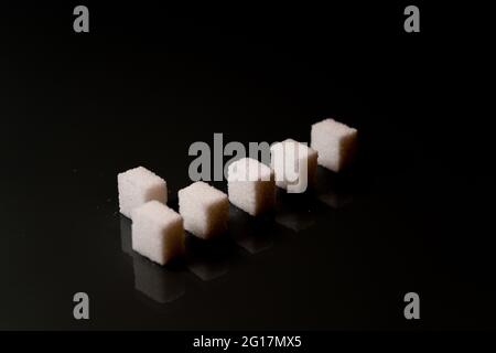 Sugar cubes in different arrangements and colored light. Arrows, Cubes, Pile, Square. Bavaria Germany Stock Photo