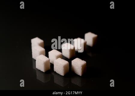 Sugar cubes in different arrangements and colored light. Arrows, Cubes, Pile, Square. Bavaria Germany Stock Photo