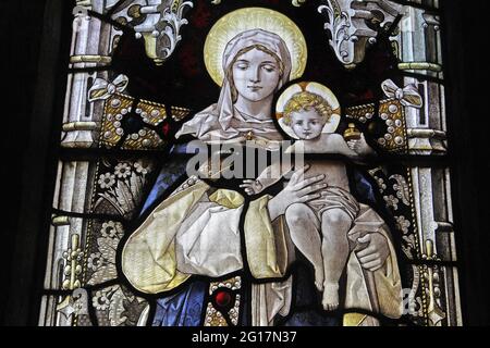 Stained glass window by Percy Bacon depicting The Blessed Virgin Mary and Child, St Leonard's Church, Rockingham, Northamptonshire Stock Photo