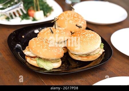 a plate with burgers on a festive table. catering service. Stock Photo