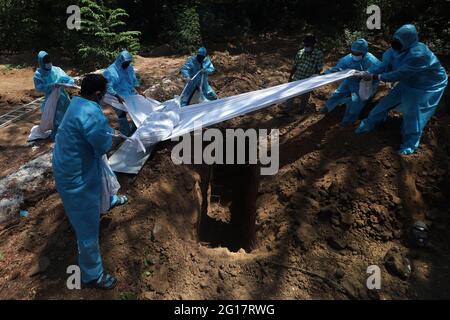 Chennai, India. 05th June, 2021. (6/5/2021) Volunteers along with graveyard workers wearing protective gear lower a body of a man who died of Covid-19 corona virus in a burial pit in Chennai. (Photo by Sri Loganathan Velmurugan/Pacific Press/Sipa USA) Credit: Sipa USA/Alamy Live News Stock Photo