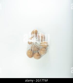 Chicken eggs wrapped in transparent white plastic. Stock Photo