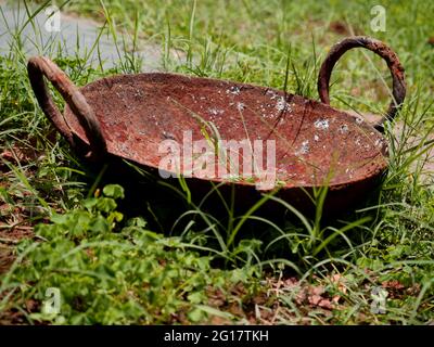 https://l450v.alamy.com/450v/2g17tkh/ancient-frying-pan-of-indian-style-presented-in-natural-green-field-2g17tkh.jpg