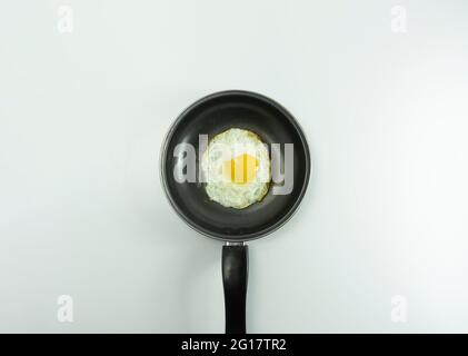 Warm omelette placed on black teflon on a white background. Stock Photo