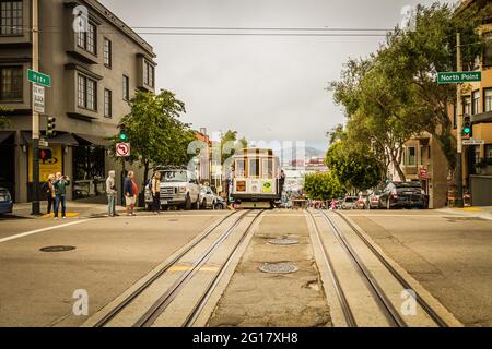 Cable car on Hyde Street and people crossing the street Stock Photo