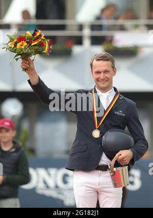 Balve, Germany. 05th June, 2021. Equestrian sport: German championship, show jumping. The show jumper Patrick Stühlmeyer celebrates his third place at the German Show Jumping Championship. Credit: Friso Gentsch/dpa/Alamy Live News Stock Photo