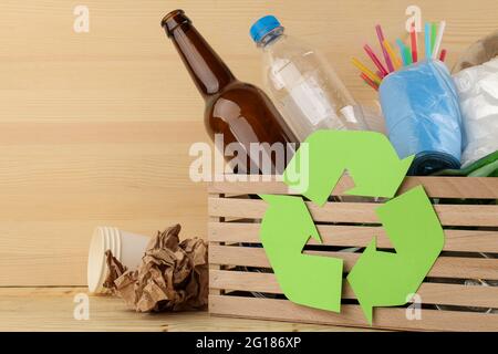 Eco symbol and trash in the box. recycling. waste recycling. on natural wooden background Stock Photo