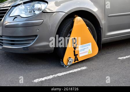 DVLA wheelclamp on front wheel of parked car, UK Stock Photo