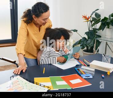 Art psychotherapy for kids. Child psychologist works with African American little girl during a psychotherapy session. Care of children's mental healt Stock Photo