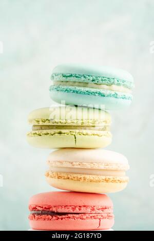 closeup heap of colorful macaroons over green background with copy space Stock Photo