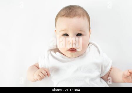 baby looks at the camera with a neutral face Stock Photo