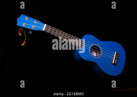 blue ukuleles on black background Stock Photo