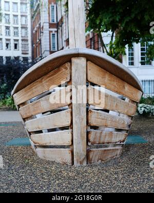 Front view of a small boat shape climbing frame for children in a playground in a city Stock Photo
