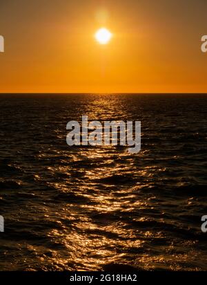 Beautiful orange sunset over the Indian Ocean viewed from Gantheaume Point near Broome WA. Stock Photo
