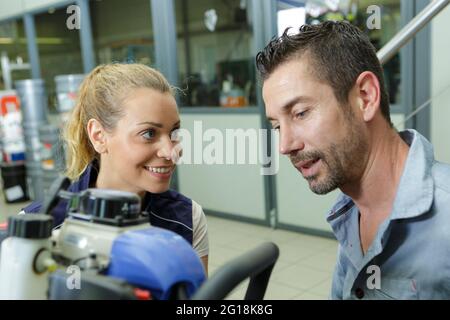 warehouse manager talking to female worker Stock Photo