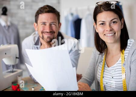 young male tailor teaching female student Stock Photo
