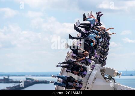 Ethnic thrill riders on the Axis thrill ride of Adventure Island pleasure park in Southend on Sea, Essex, UK. Female riders wearing hijab headscarves Stock Photo