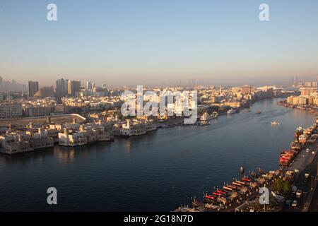 Dubai at sunrise. The streets are ampty and  the abras are still in parking position, ready for the morning rush. On the opposite side is the gold sou Stock Photo