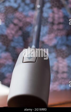 Colorful umbrella with an arrow up and arrow down button on a wooden table in the house Stock Photo