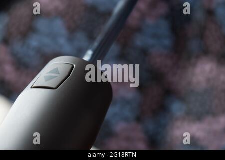 Colorful umbrella with an arrow up and arrow down button on a wooden table in the house Stock Photo