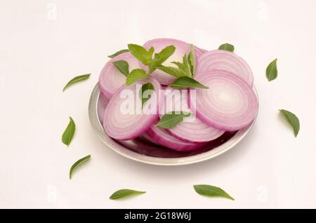 closeup sliced onion in the plate isolated on white background. Stock Photo