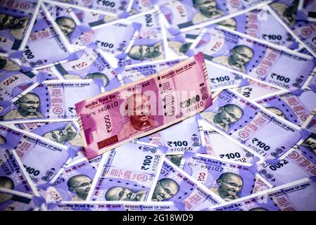 Two thousands rupees note on Indian one hundreds rupees notes background. Stock Photo
