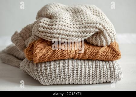 A stack of neatly folded warm knitwear, wool close up. Stock Photo