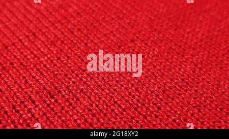 Red Knitted Wool Fabric in Diagonal Patterns with Selective Focus Stock Photo
