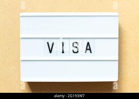 Lightbox with word visa on wood background Stock Photo