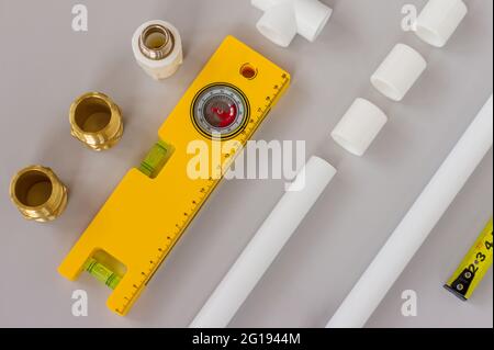 Plumbing fixtures and piping parts with measuring level and ruler. Plumbing flat lay concept background with copy space Stock Photo