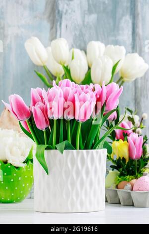 Pink and white tulips on Easter table. Postcard motif. Stock Photo