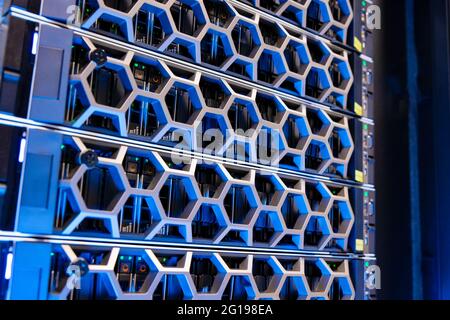 Virtual Modern Hard Drives In Illuminated Blue Datacenter Stock Photo