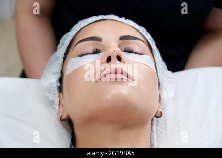 Eyelash Extension Procedure. Woman Eye with Long Eyelashes Stock Photo