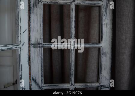 Vintage wooden window with fading white paint on a dark background ...